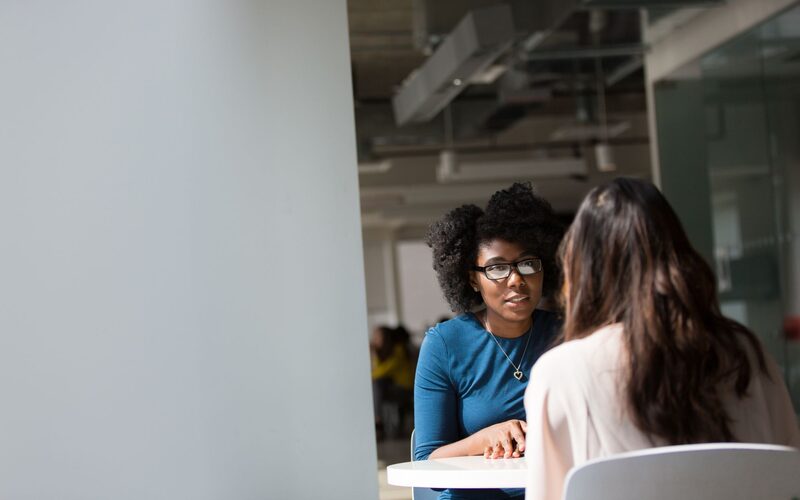 Manager coaching a new representative one on one at the office