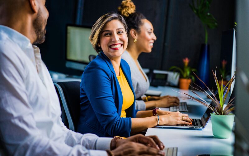Energetic sales floor with representatives working together at their desks
