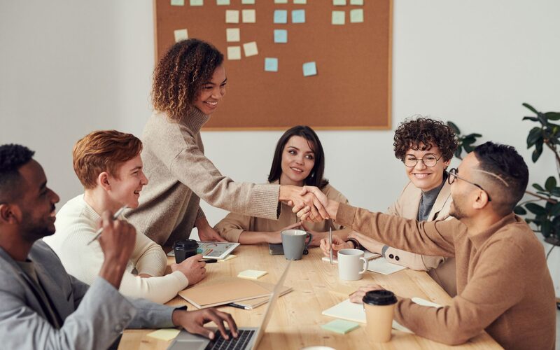Team leaders reviewing weekly sales targets together around a conference table